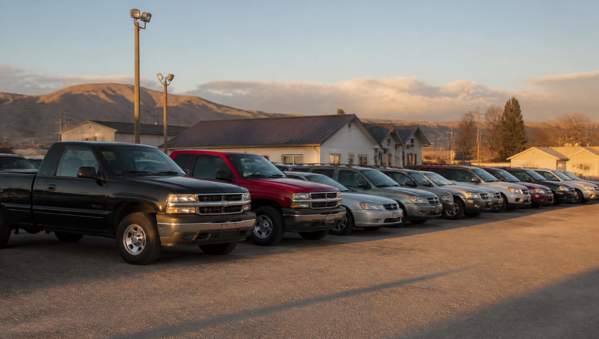 Used vehicles parked at a small independent dealership lot in southern Idaho